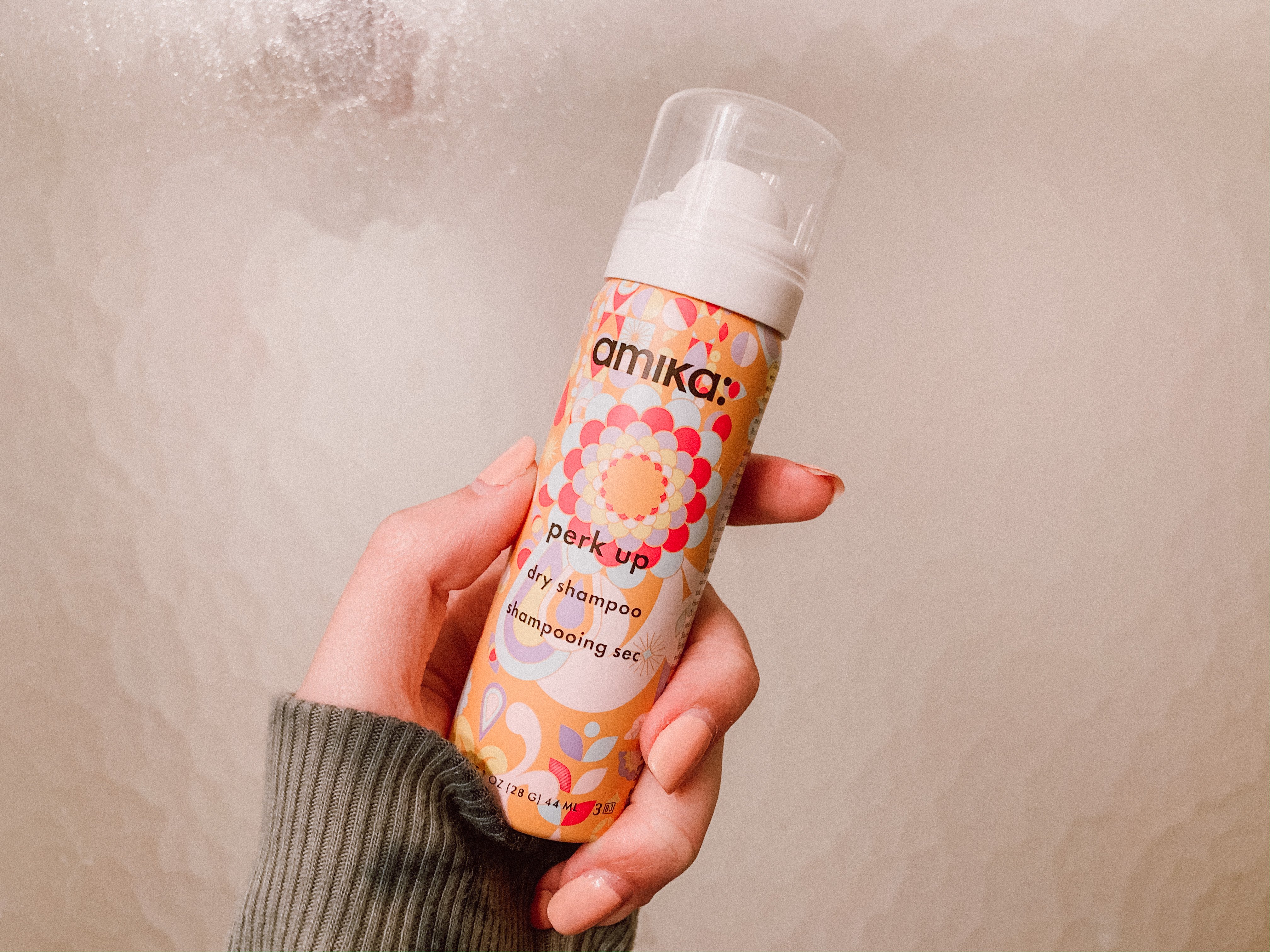 Me holding Amika\'s dry shampoo.