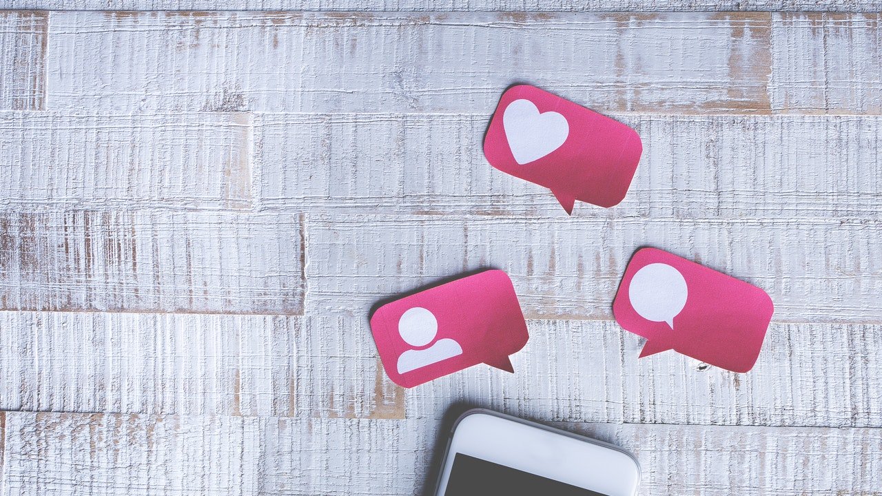 A white phone with Instagram cutouts above it