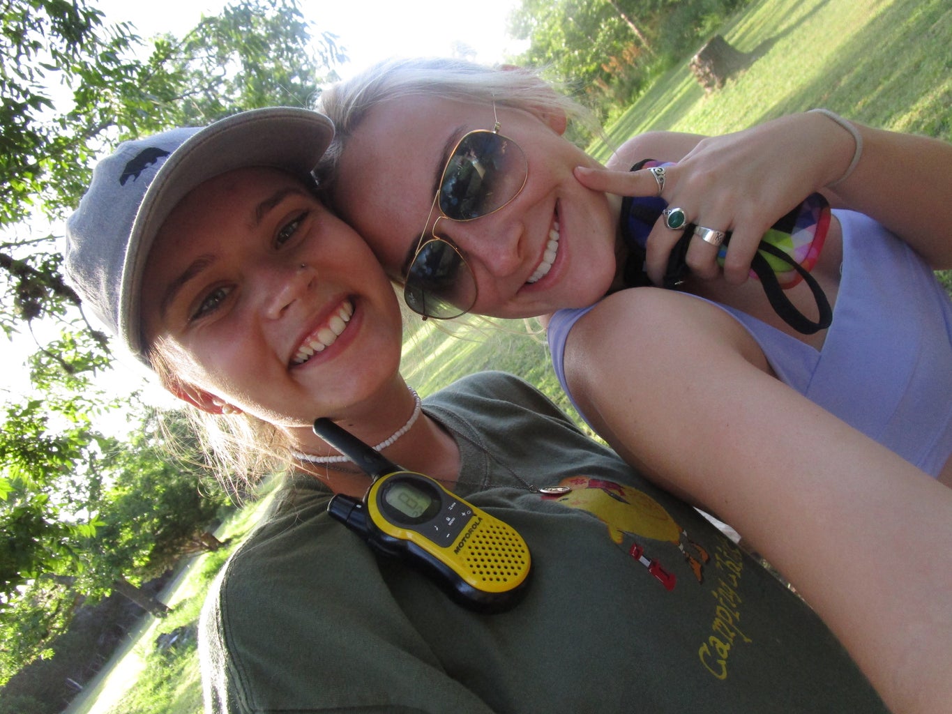 two girls smiling with walkie talkies
