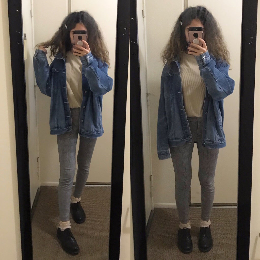 mirror selfie of a girl wearing a beige sweater, denim jacket, and plaid pants
