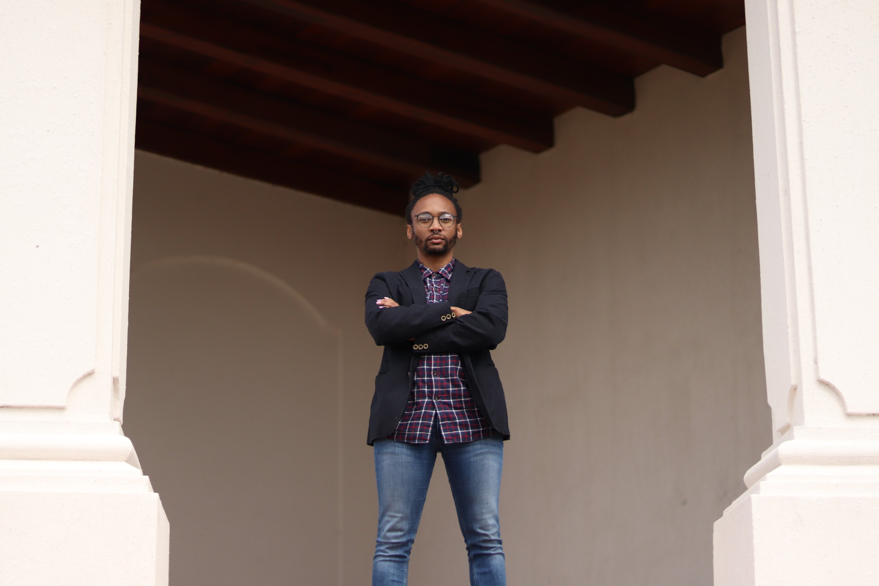 A Xhosa man, with his arms crossed, stands proud.