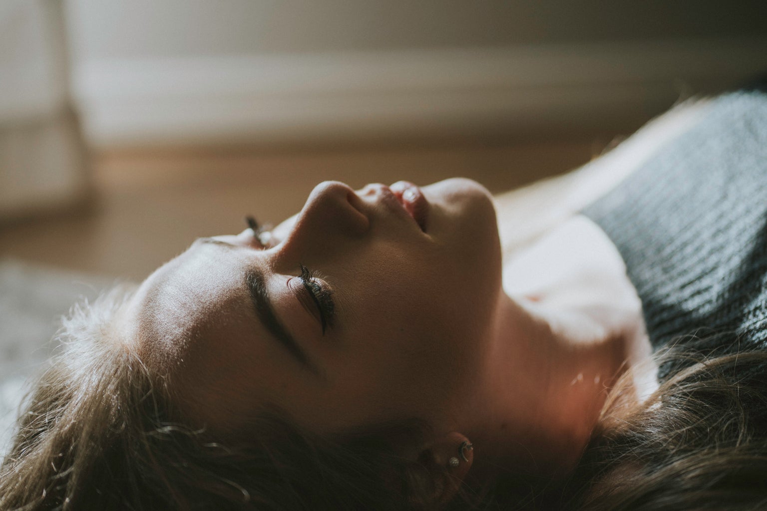 selective focus photography of woman lying on floor