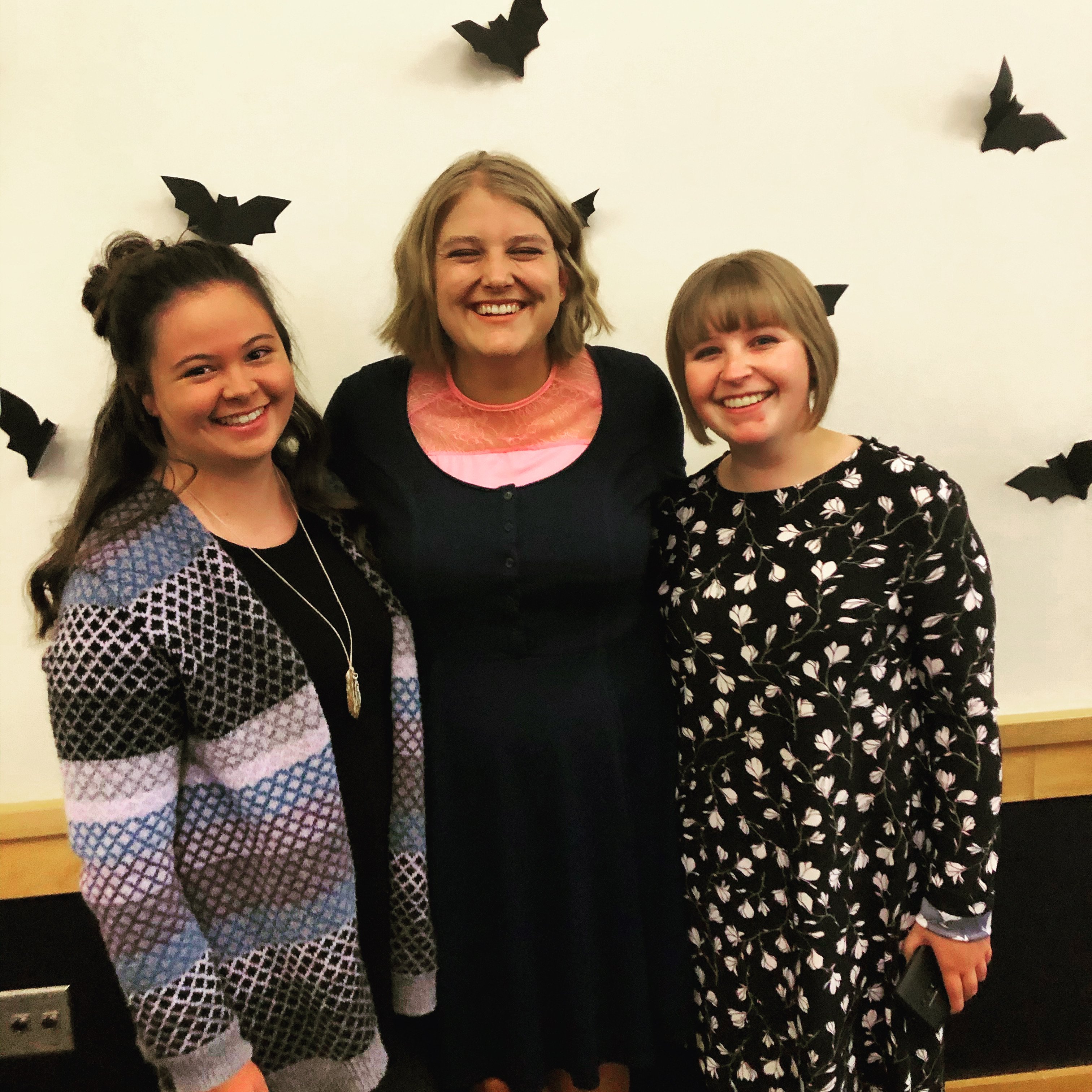 Three girls dressed nice, smiling