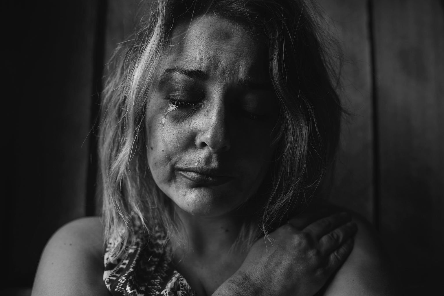 woman crying in b&w photo