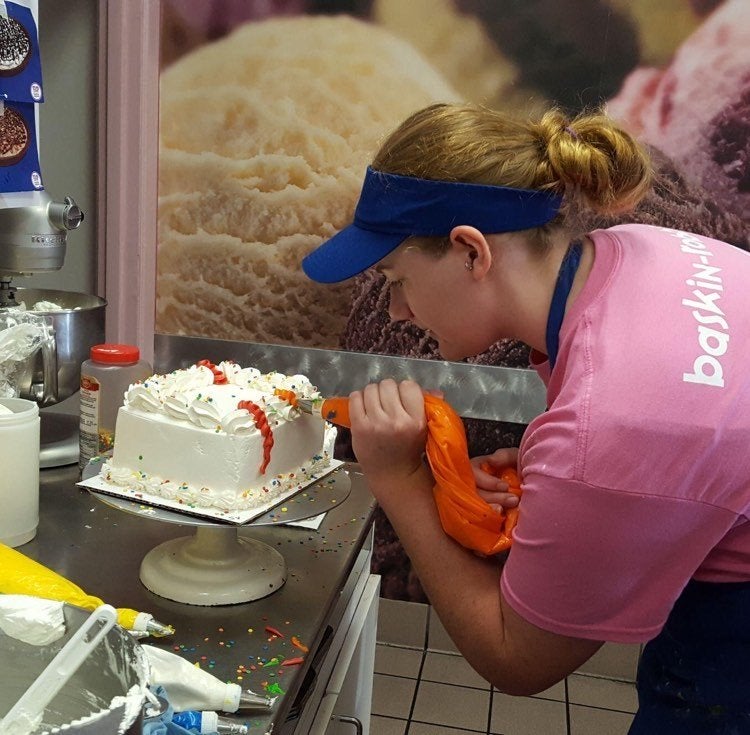 Devon decorating an ice cream cake at Baskin Robbins