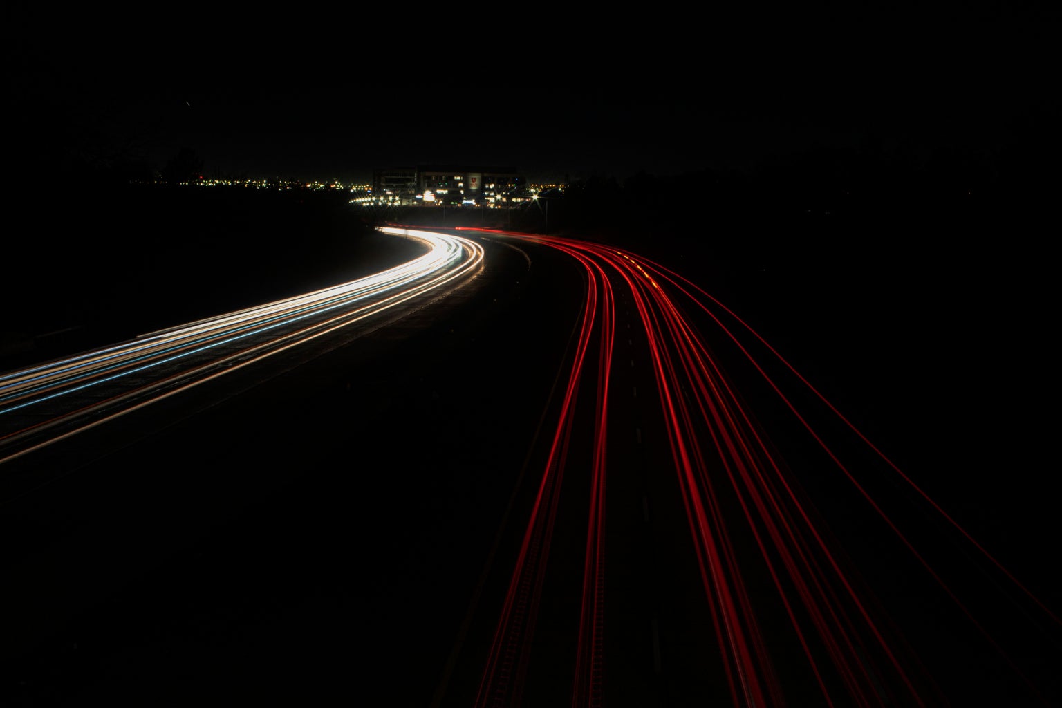 Night photo of cars on a freeway.
