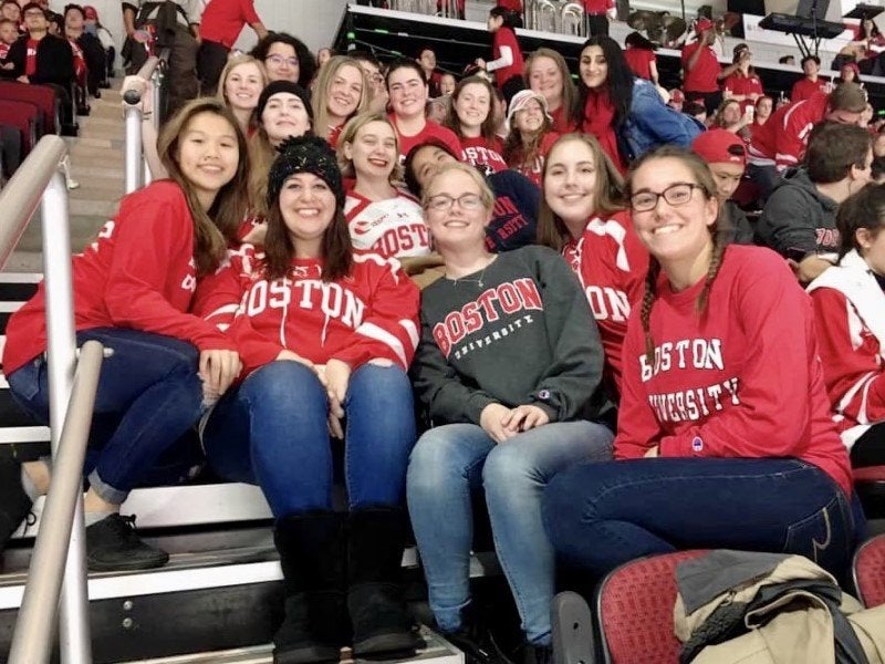 group of friends at a Boston University hockey game