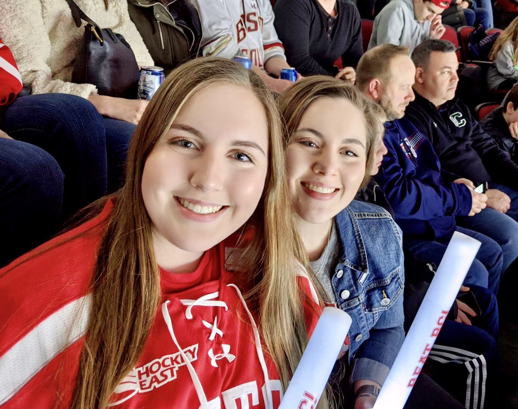 sisters at a Boston University hockey game