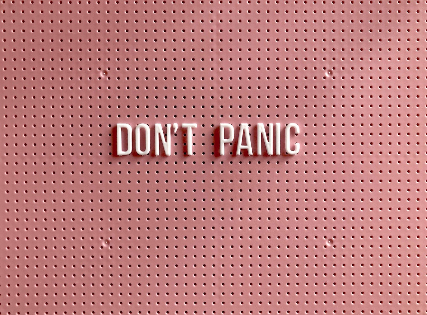 Don\'t Panic sign with pink backdrop