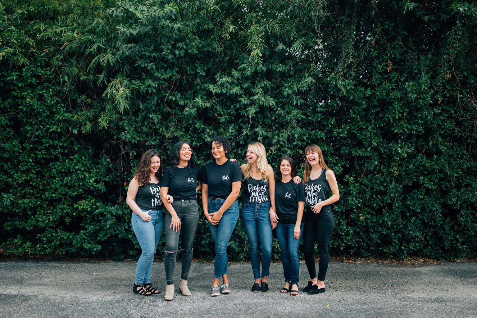 a group of women wearing shirts that say \"Babes Who Hustle\" or \"bwh\"