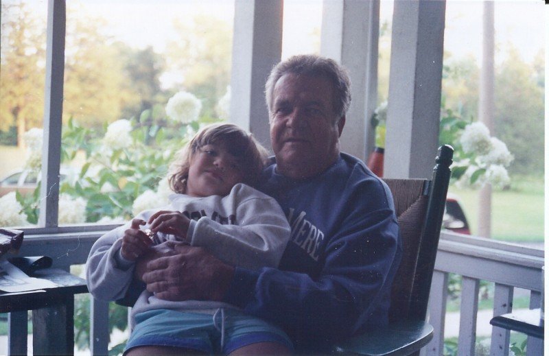 child sitting on porch with man