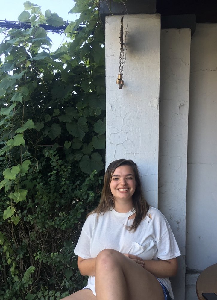 women sitting on porch smiling