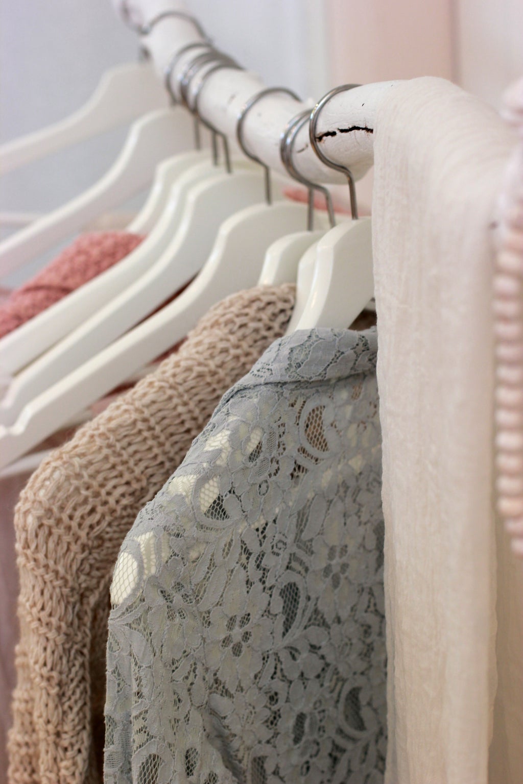 clothes hanging on a white rack