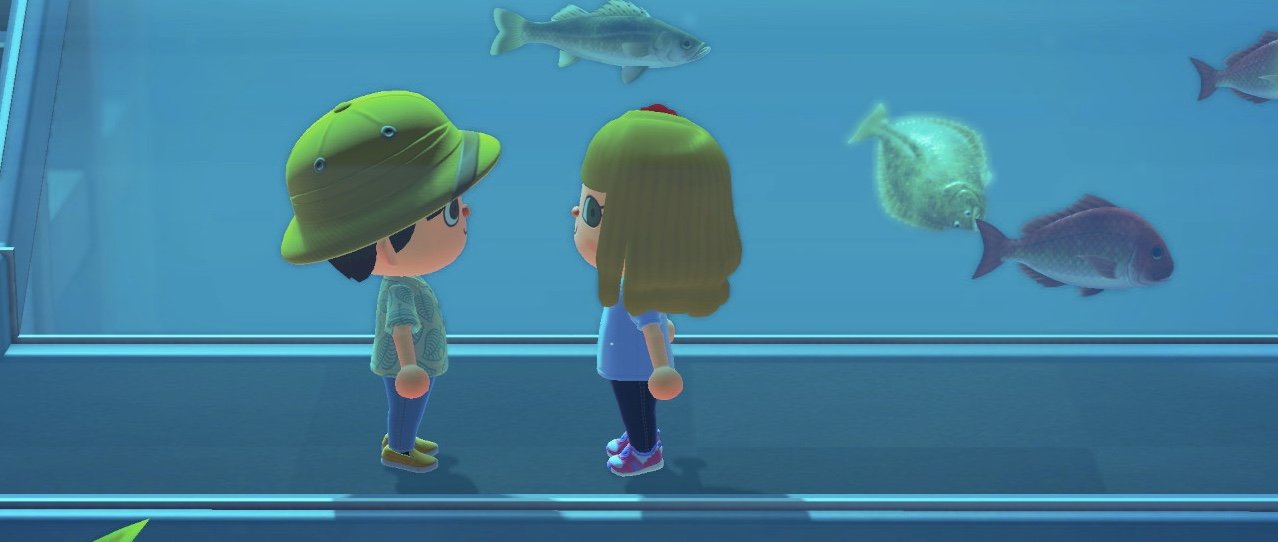 two animal crossing characters standing in an aquarium