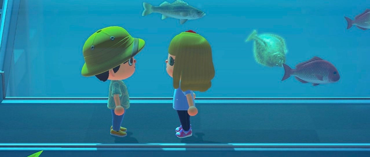 two animal crossing characters standing in an aquarium