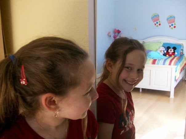 A young girl looking in the mirror.