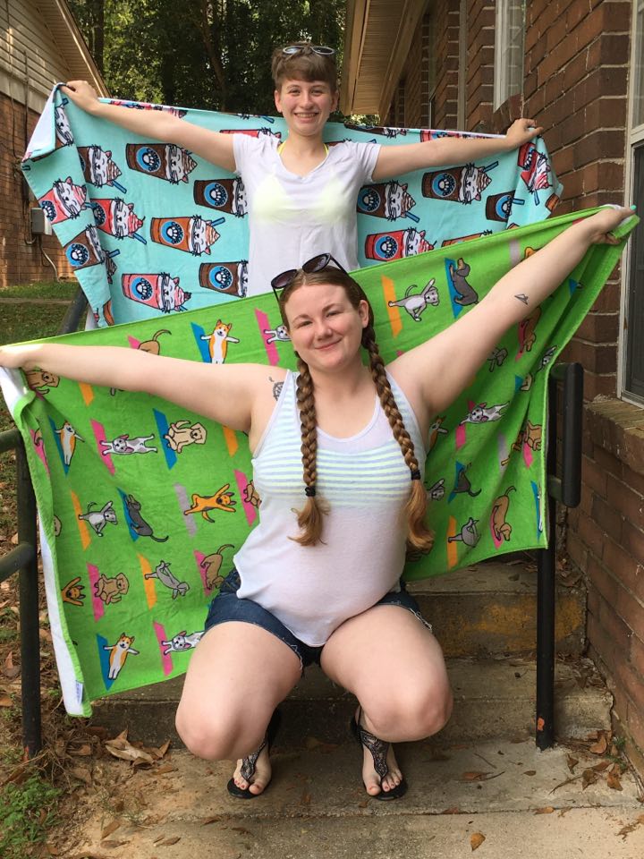 Devon and Lindsey pose with white shirts and beach towels
