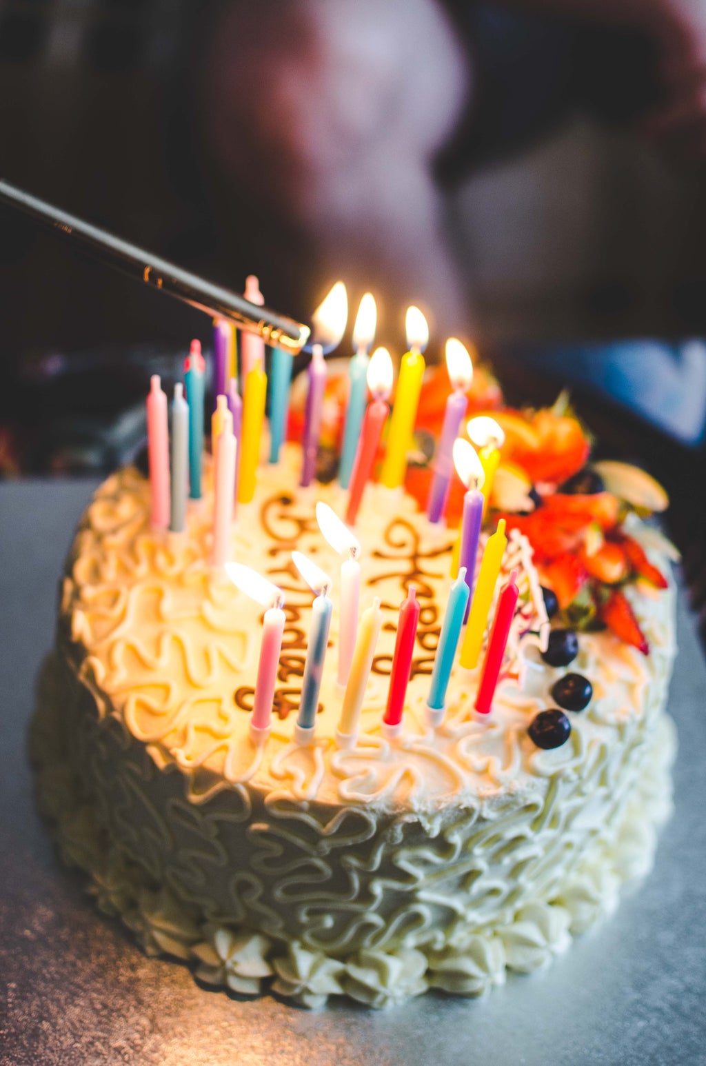 Candles being lit on birthday cake