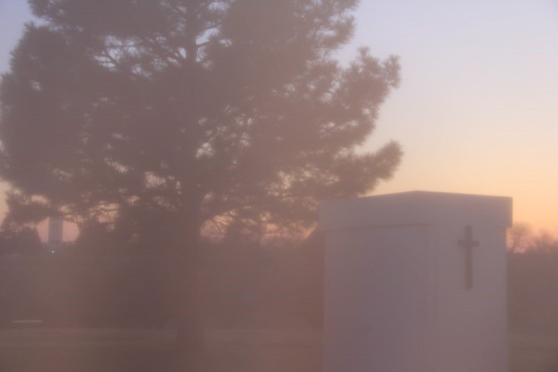 A cemetery entrance at sunset.