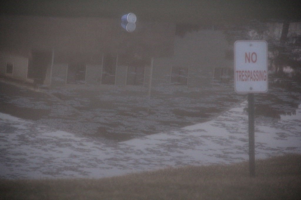 A no trespassing sign near a pond.