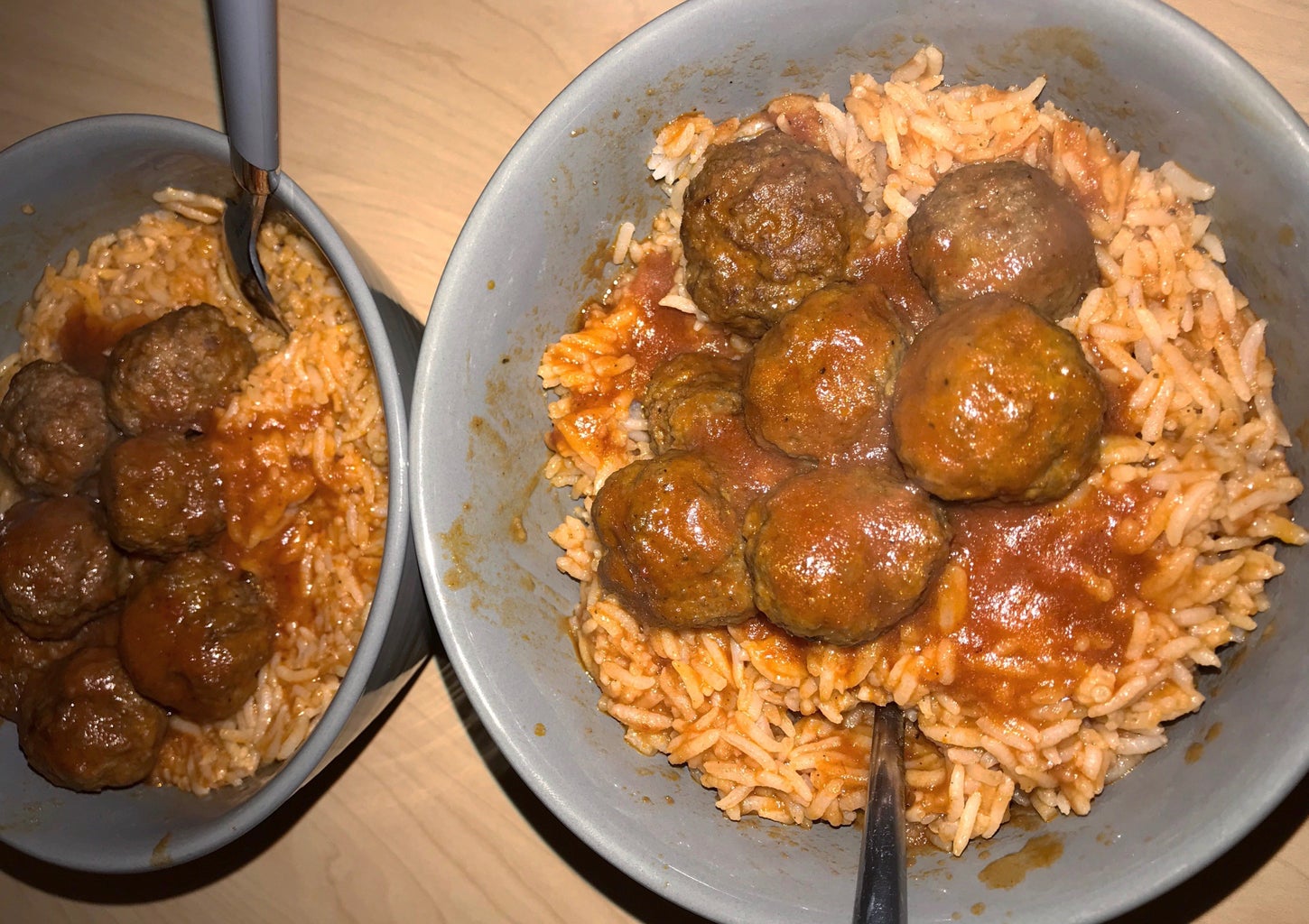 two bowls filled with meatballs and rice