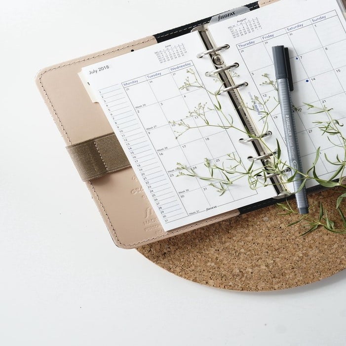 A beautiful monthly calendar covered by green leaves