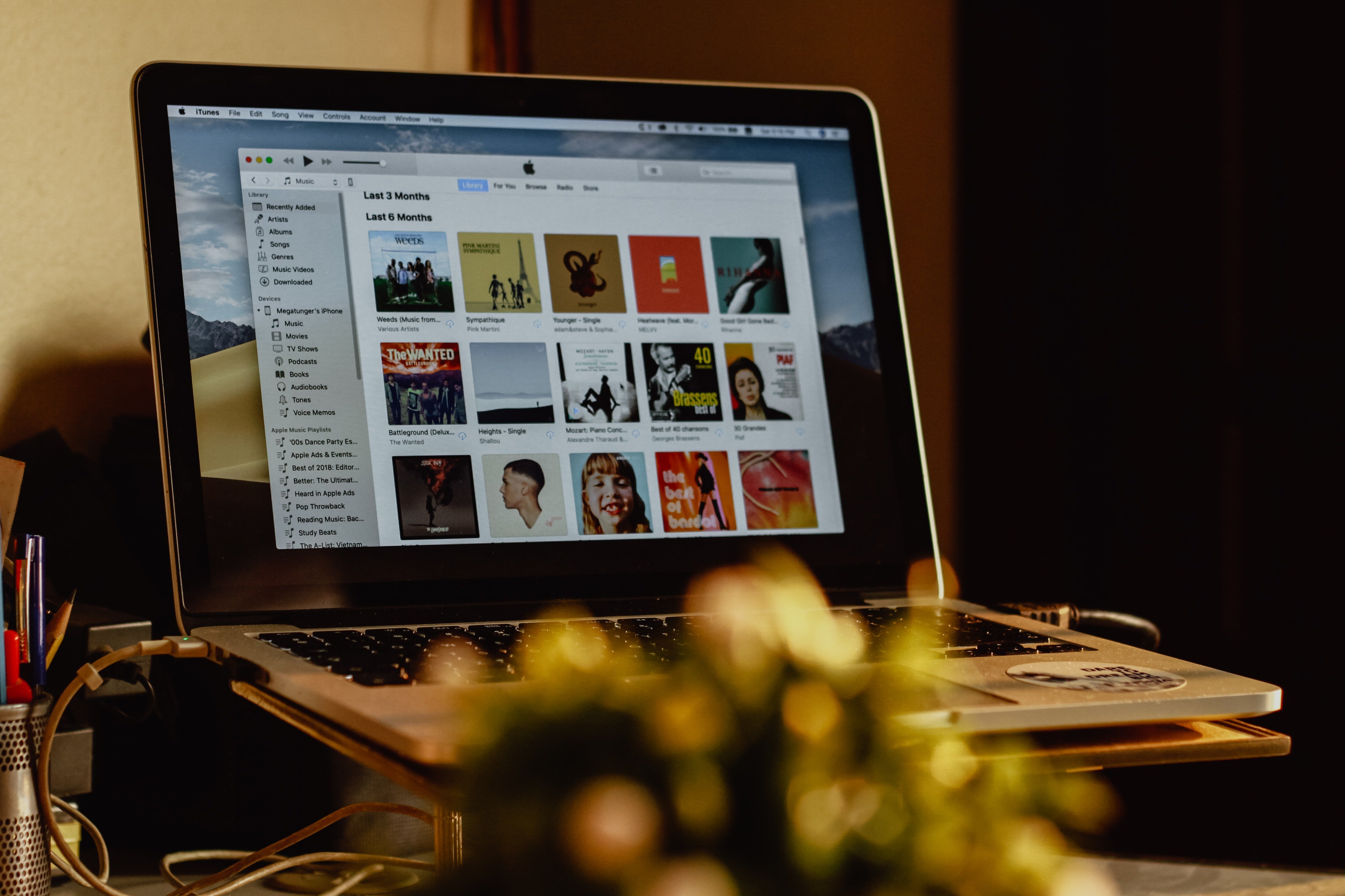 person playing music on a laptop on a desk