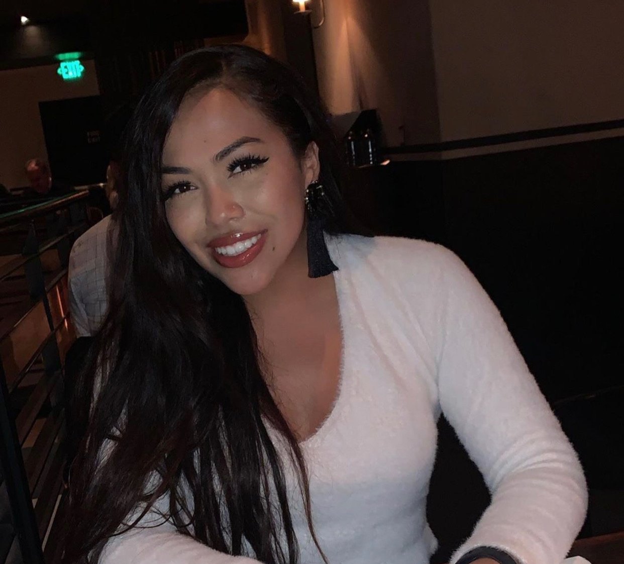 Woman sitting at a table smiling