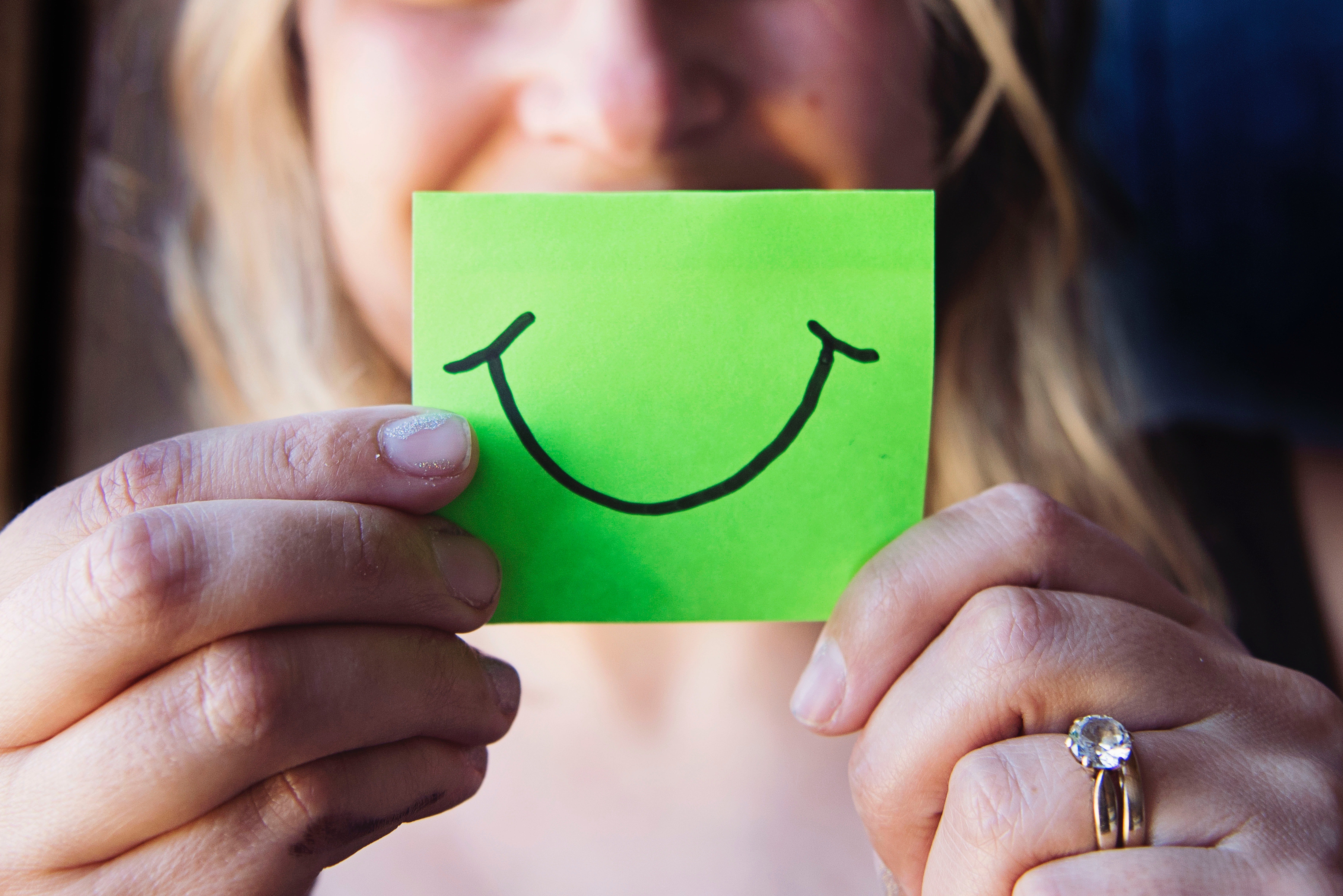 woman holding a smiling balloon
