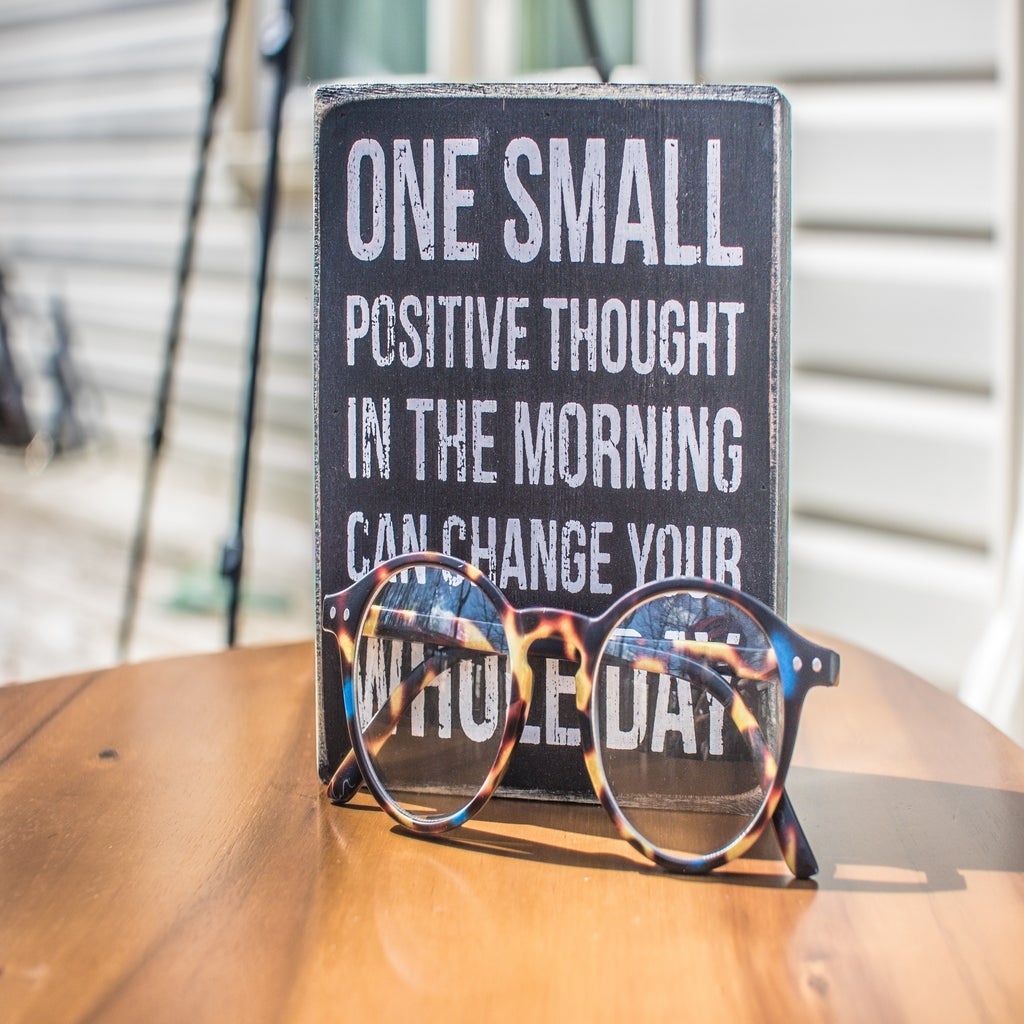 sign with positive messageand eyeglass