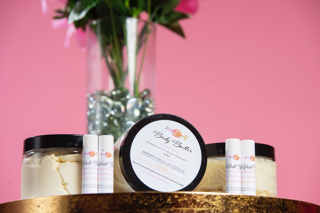 DeVosh Beauty products with a vase of flowers in the background