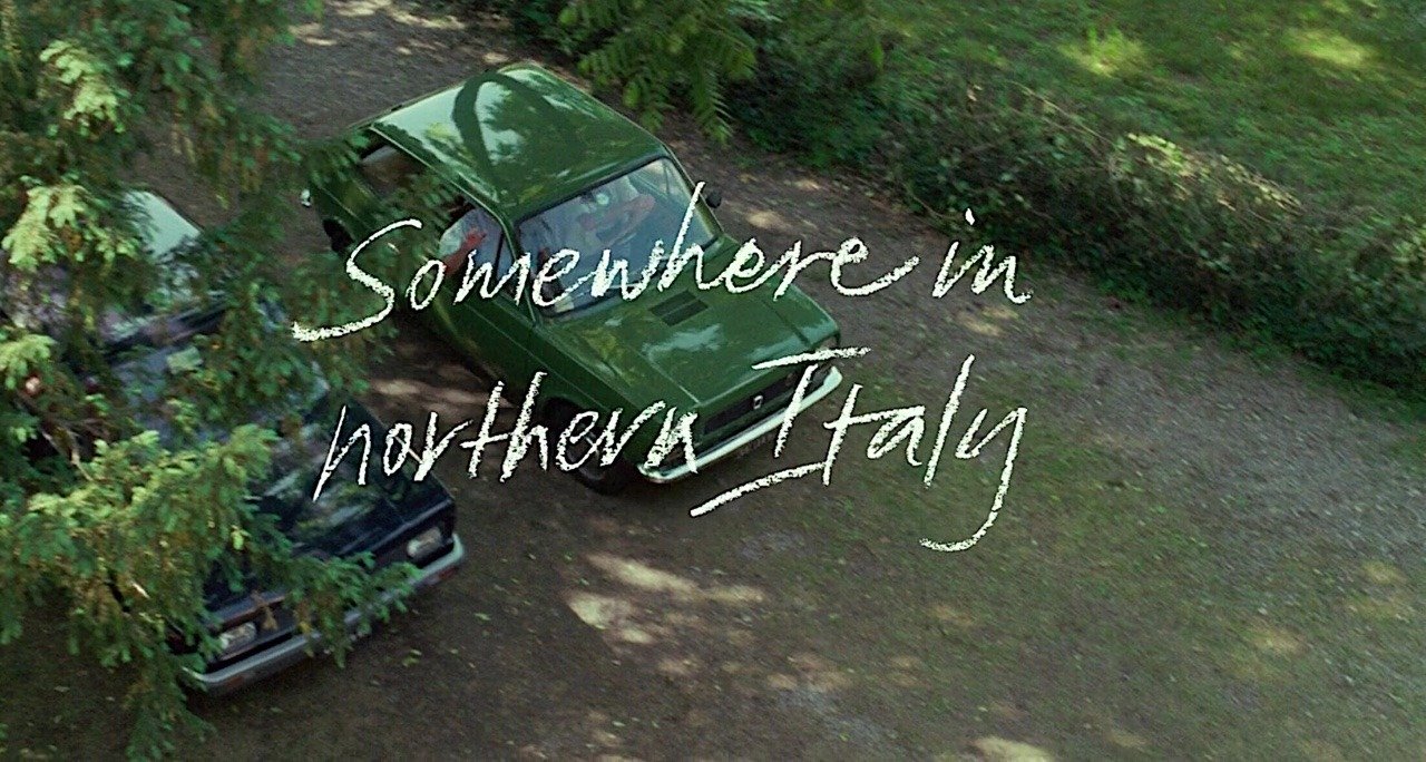 scene from \"Call Me By Your Name\", car with words \"Somewhere in Northern Italy\"