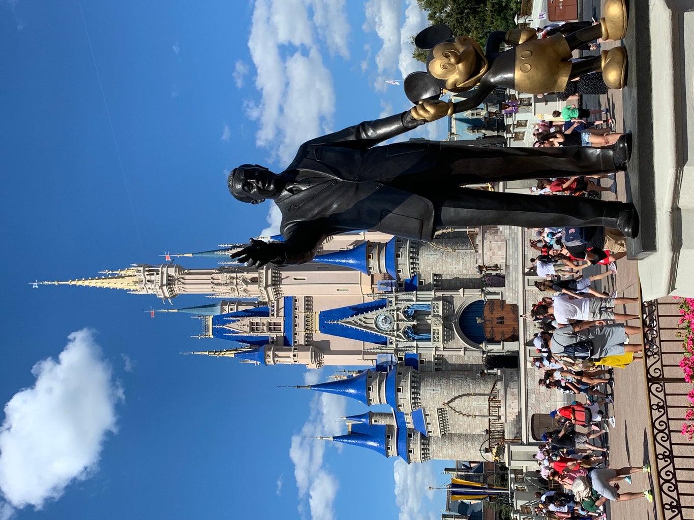 Walt Disney and Mickey Mouse Statue in front of Cinderella\'s castle at Disney World in Orlando, Florida