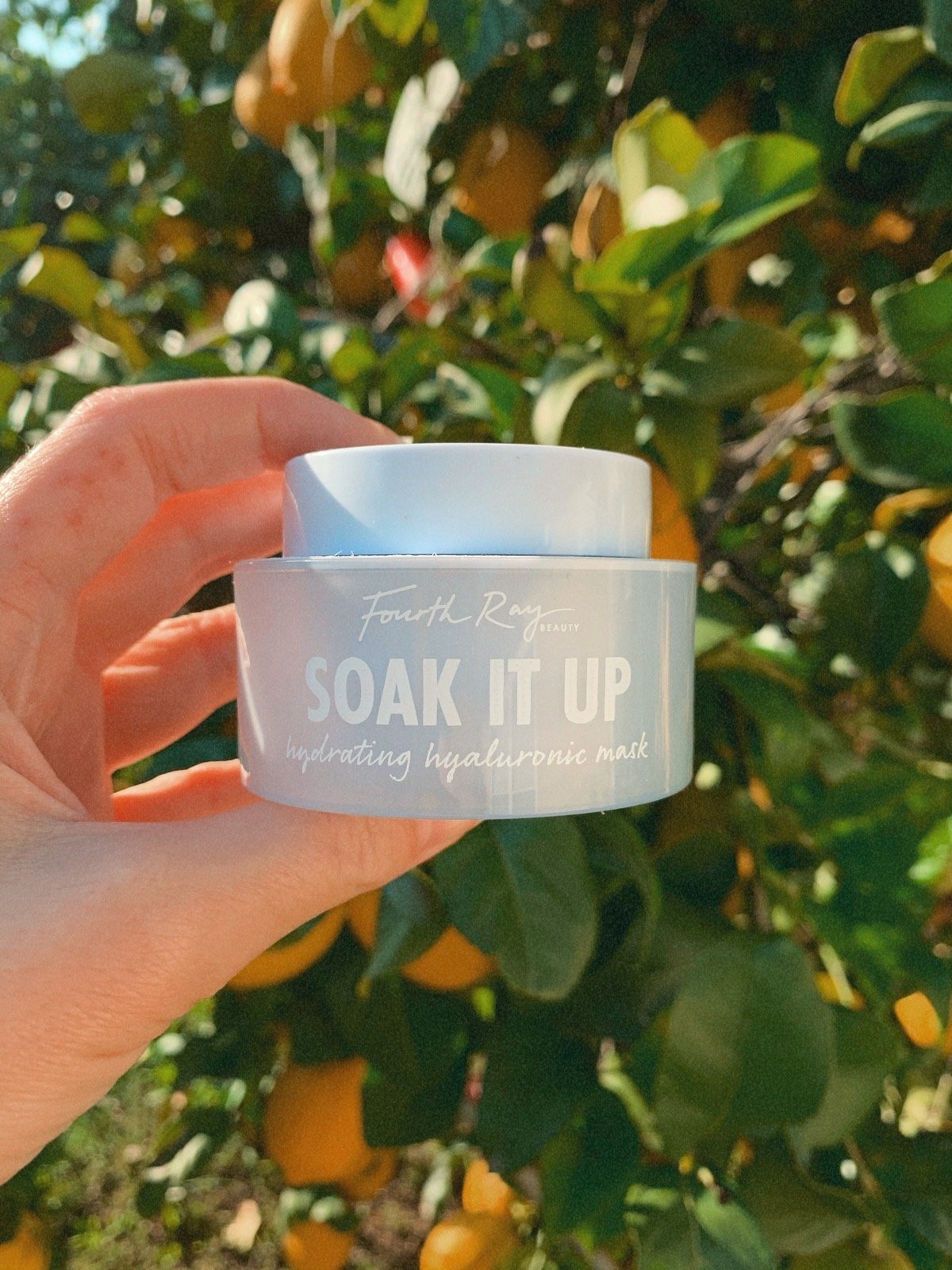 face mask in front of a lemon tree