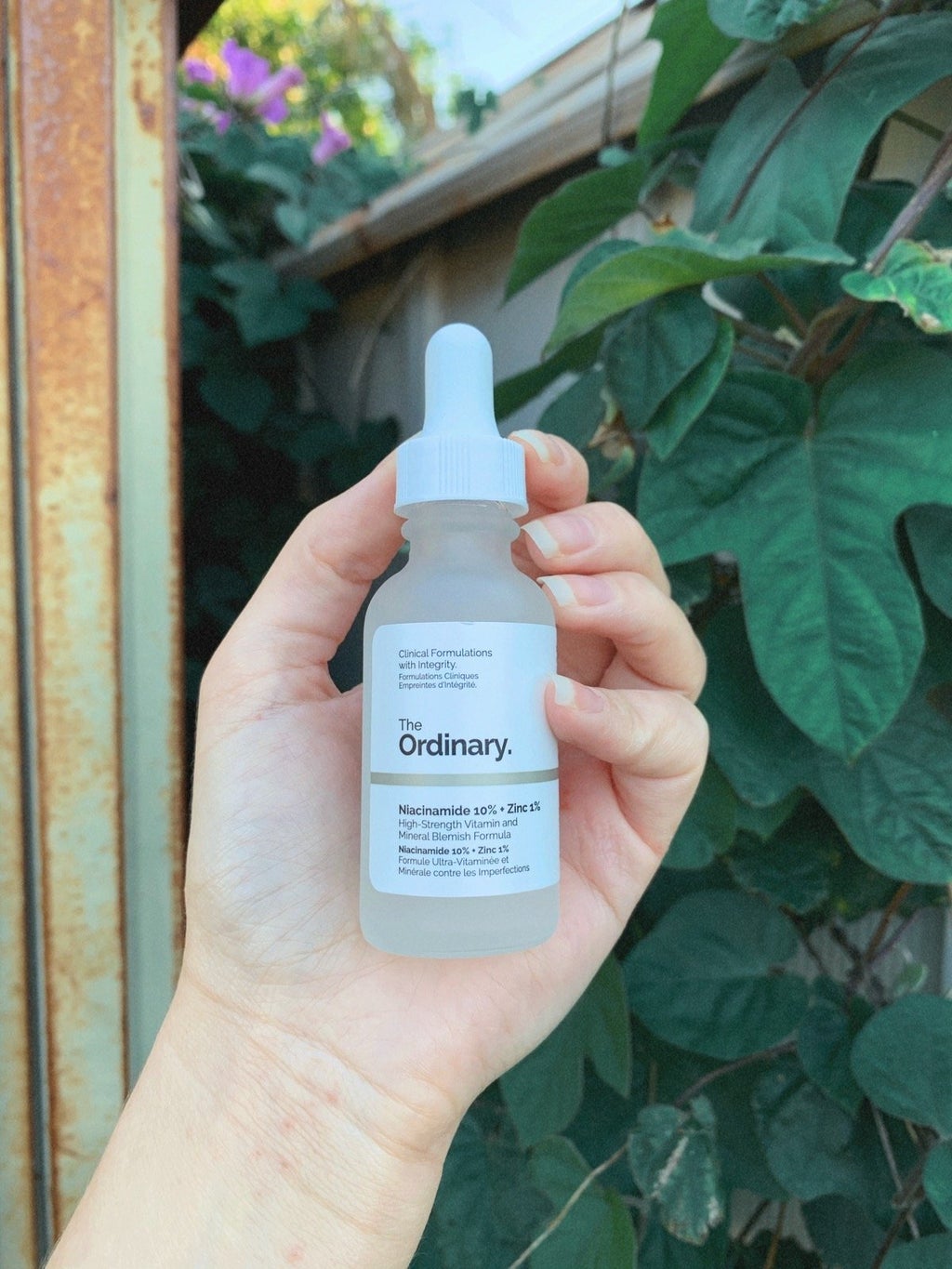 skincare product in front of leaves outside