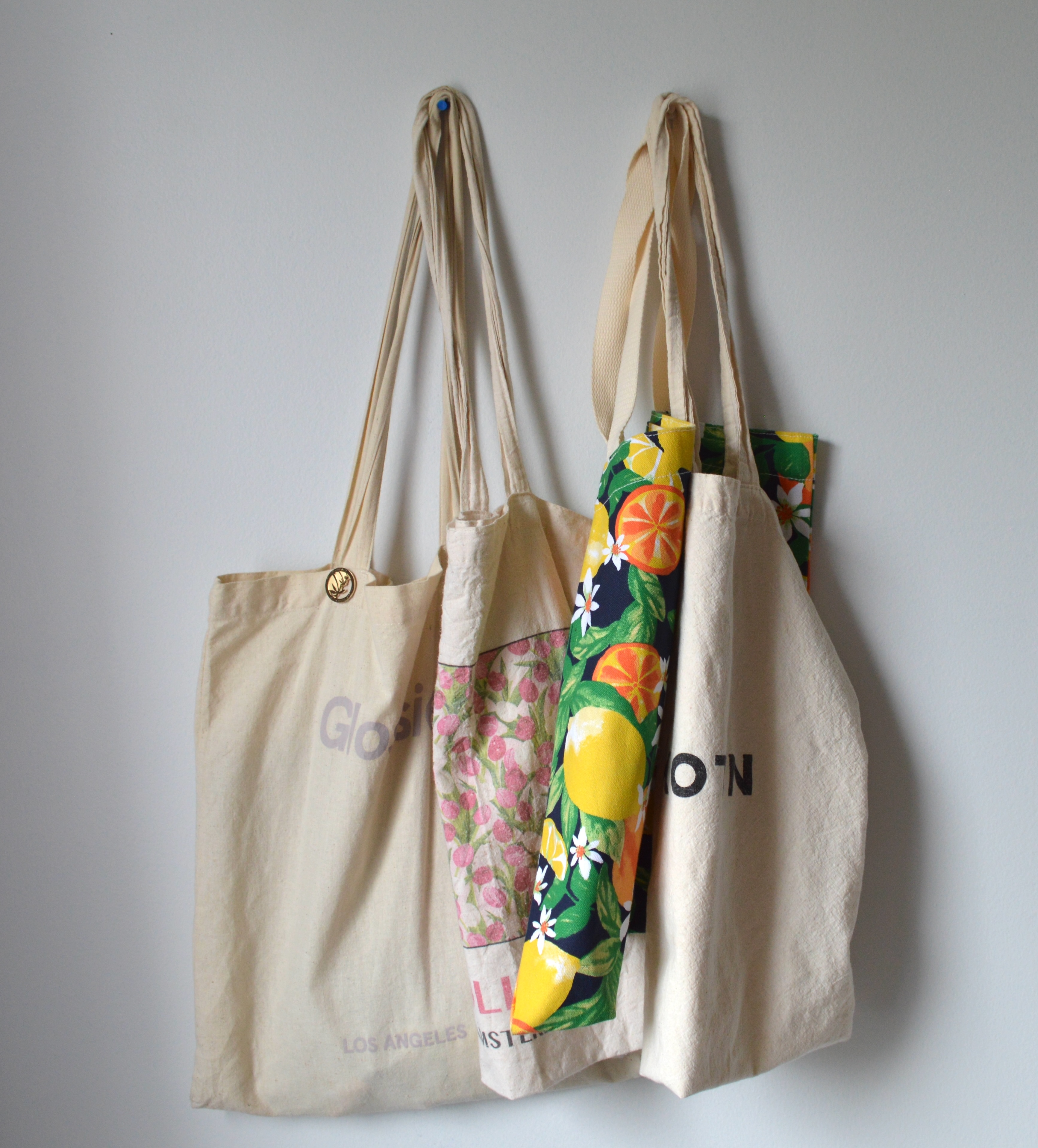 array of beige tote bags on clear background