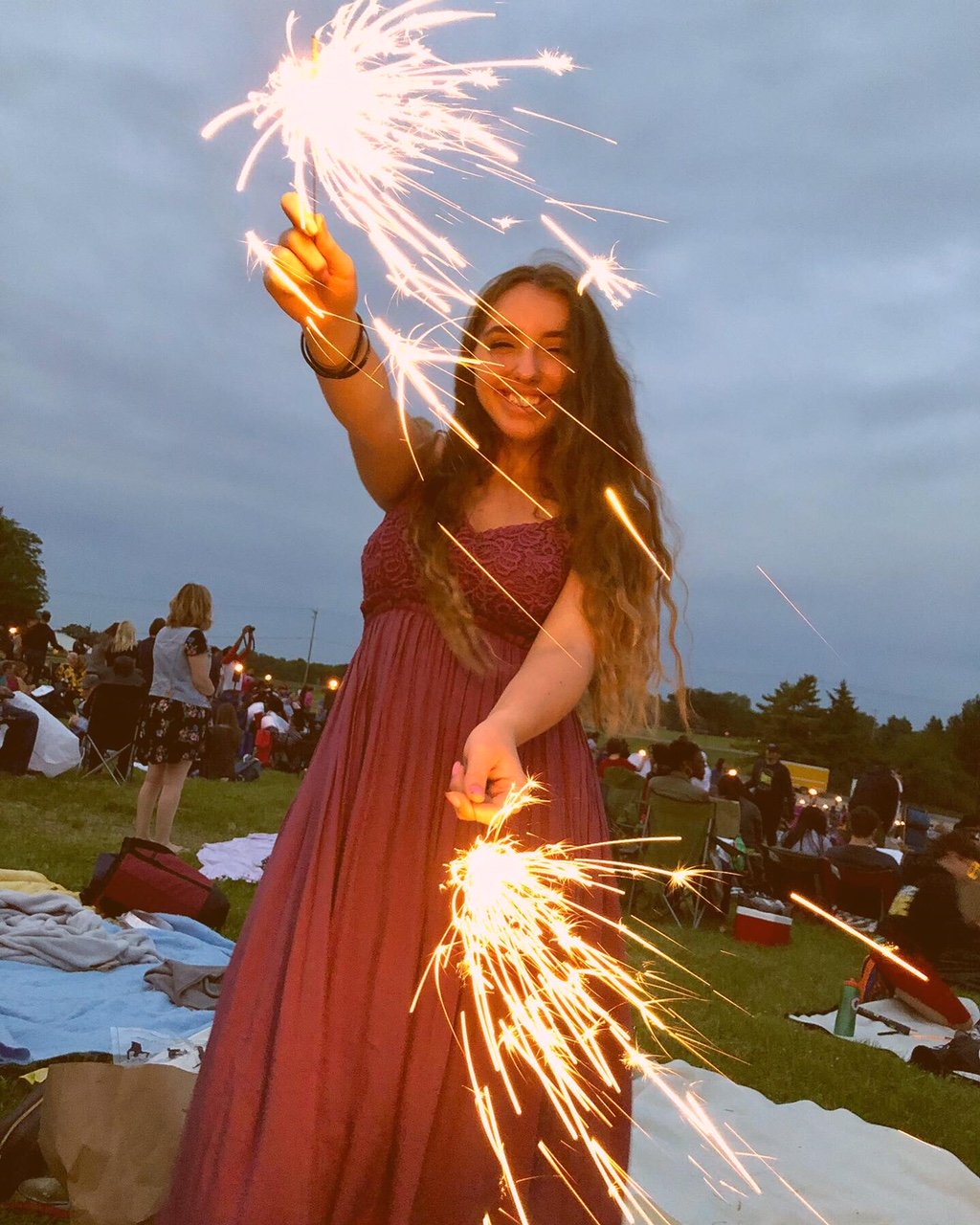 Girl in purple dress with sparklers at the Lights Fest