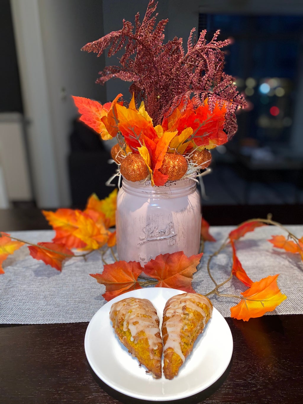 completed fall centerpiece with two pumpkin spice scones in front