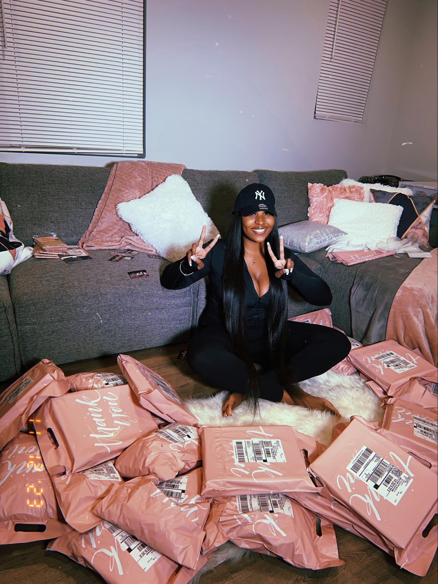 SHOPKAID poses with packages around her