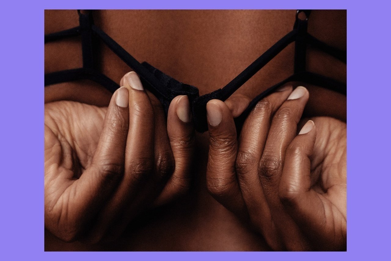 person unfastening bra