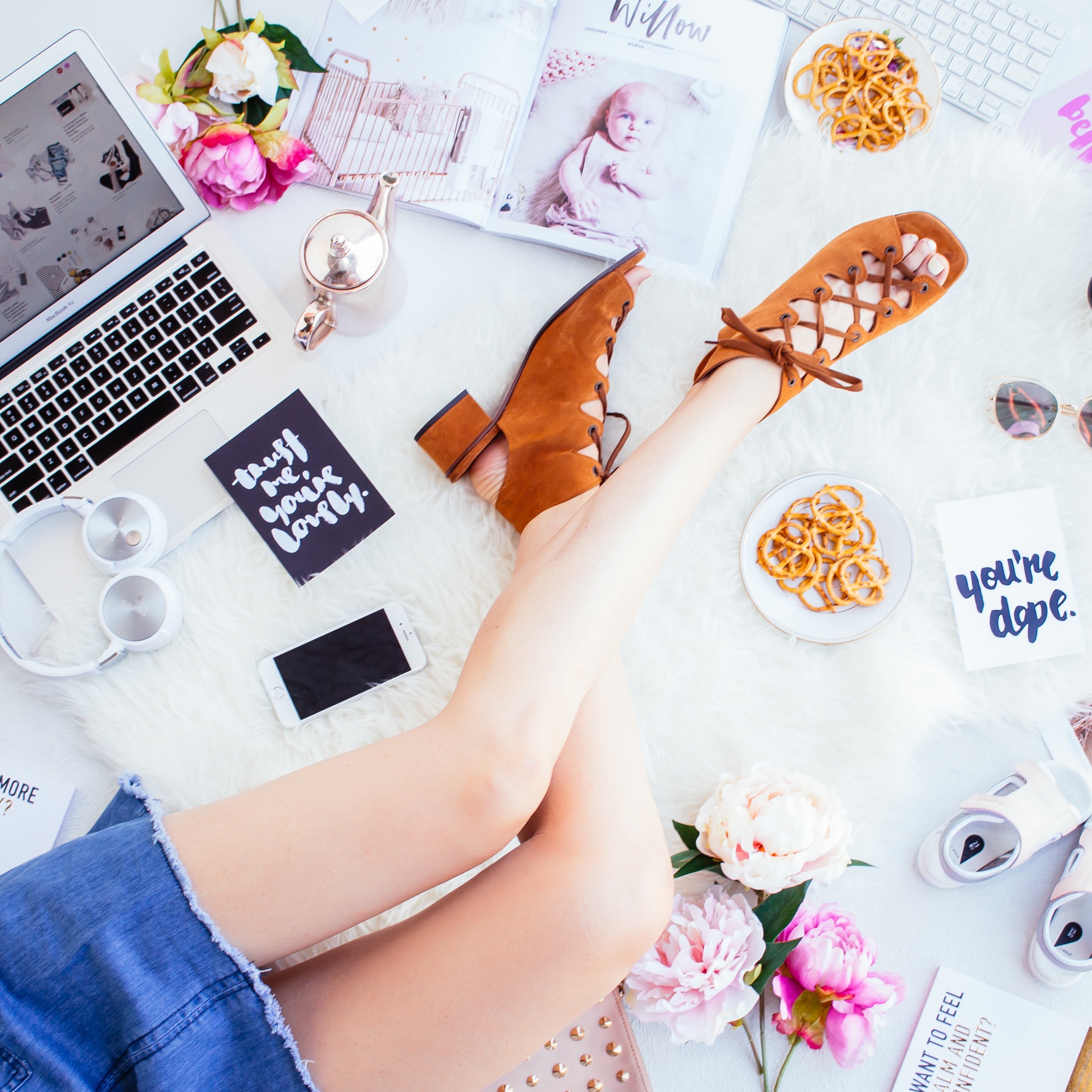 top down view of person sitting on shag rug with various items on the ground
