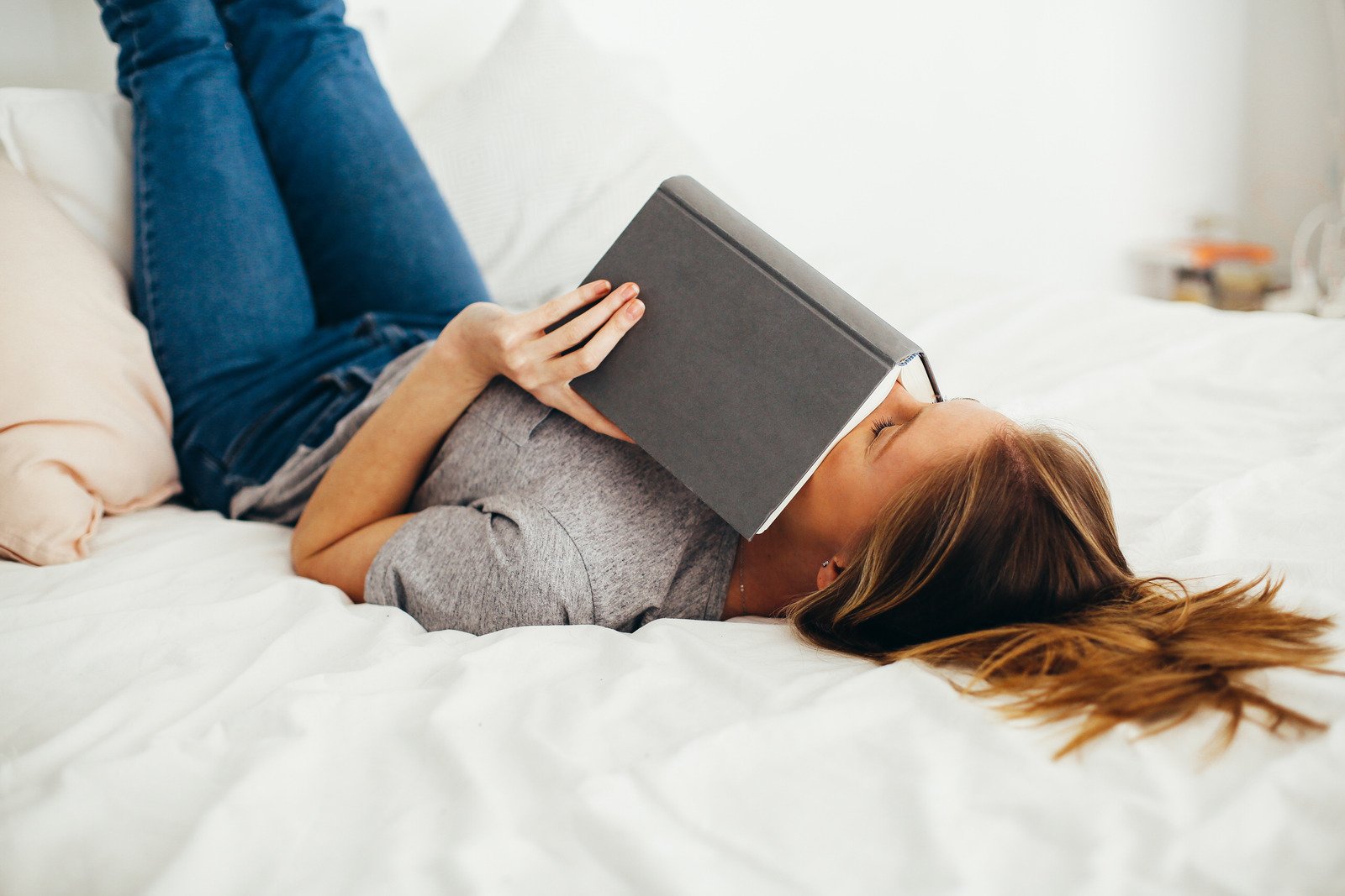 Woman reading a book in bed