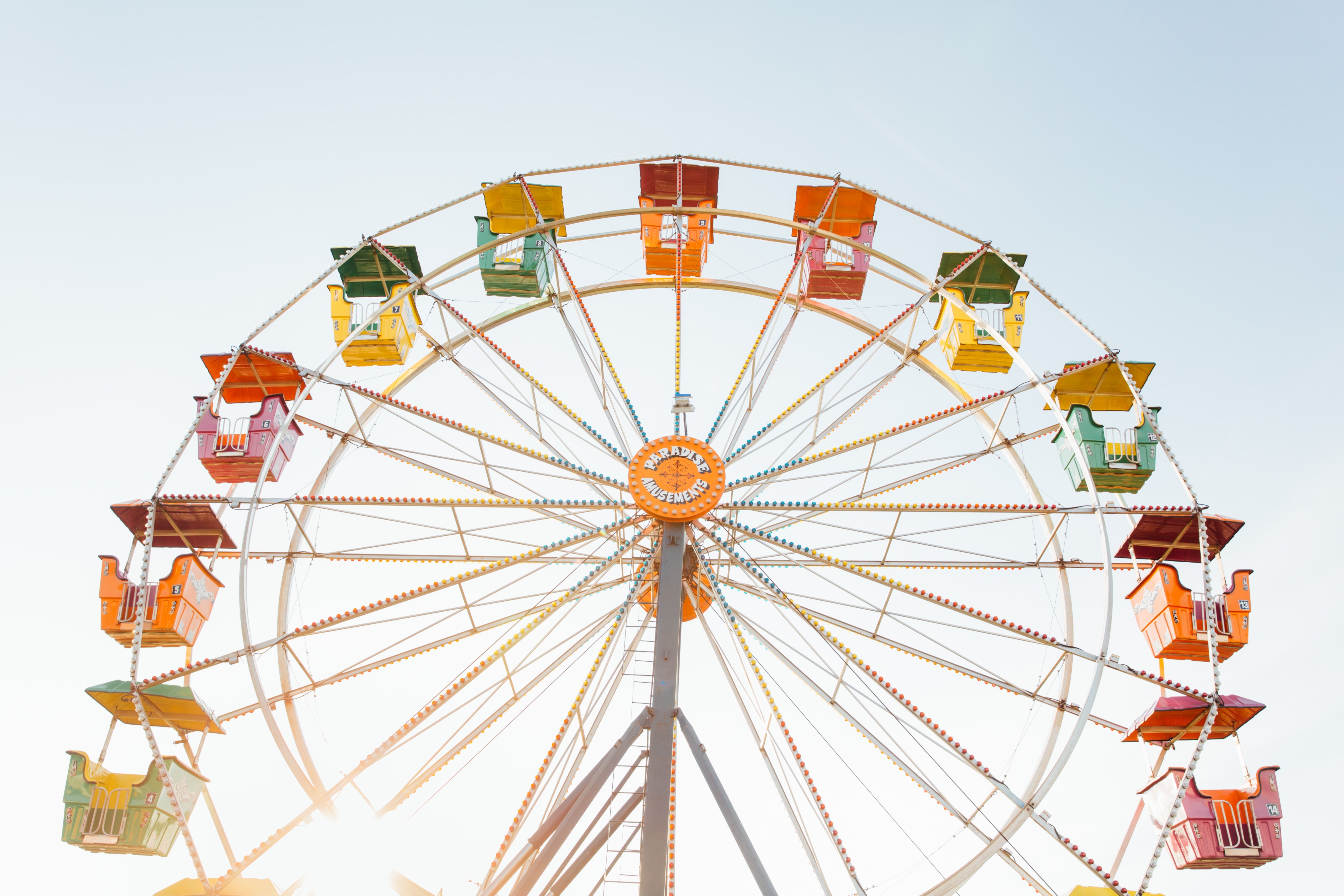 worm\'s eye view of red, orange, and yellow Ferris wheel