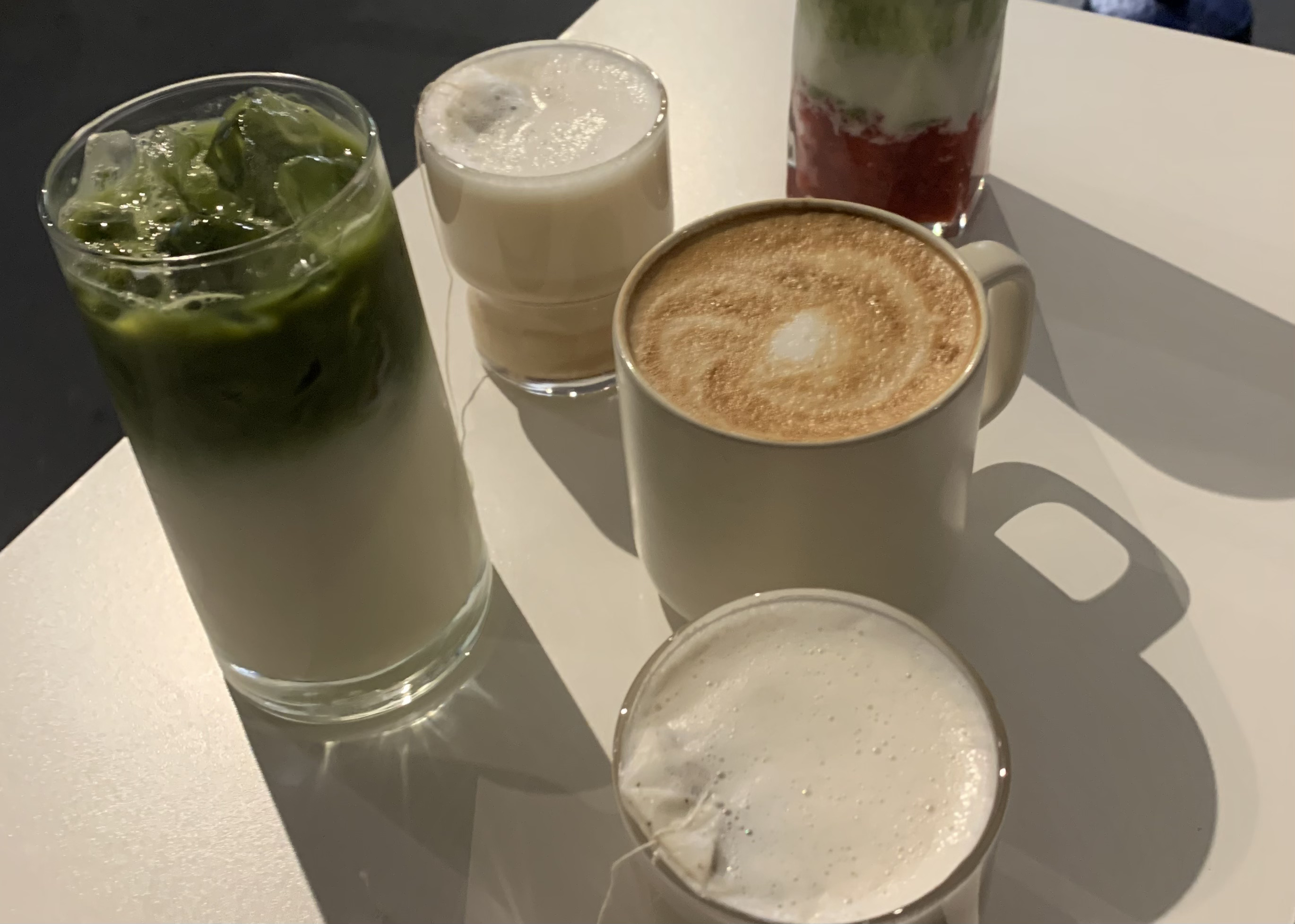 Coffee cups from Playground cafe scattered around the table.