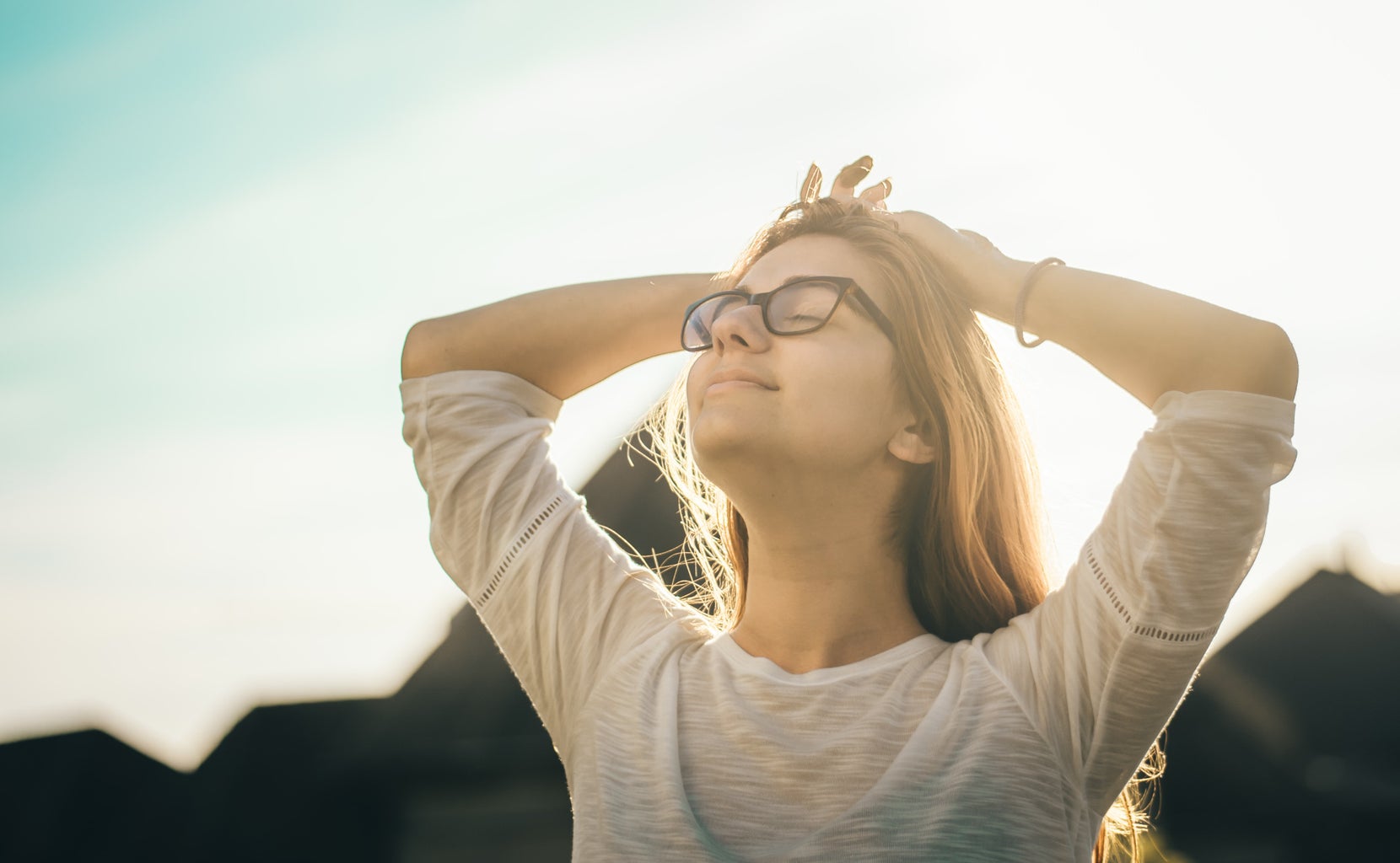 person stretching outside in sun