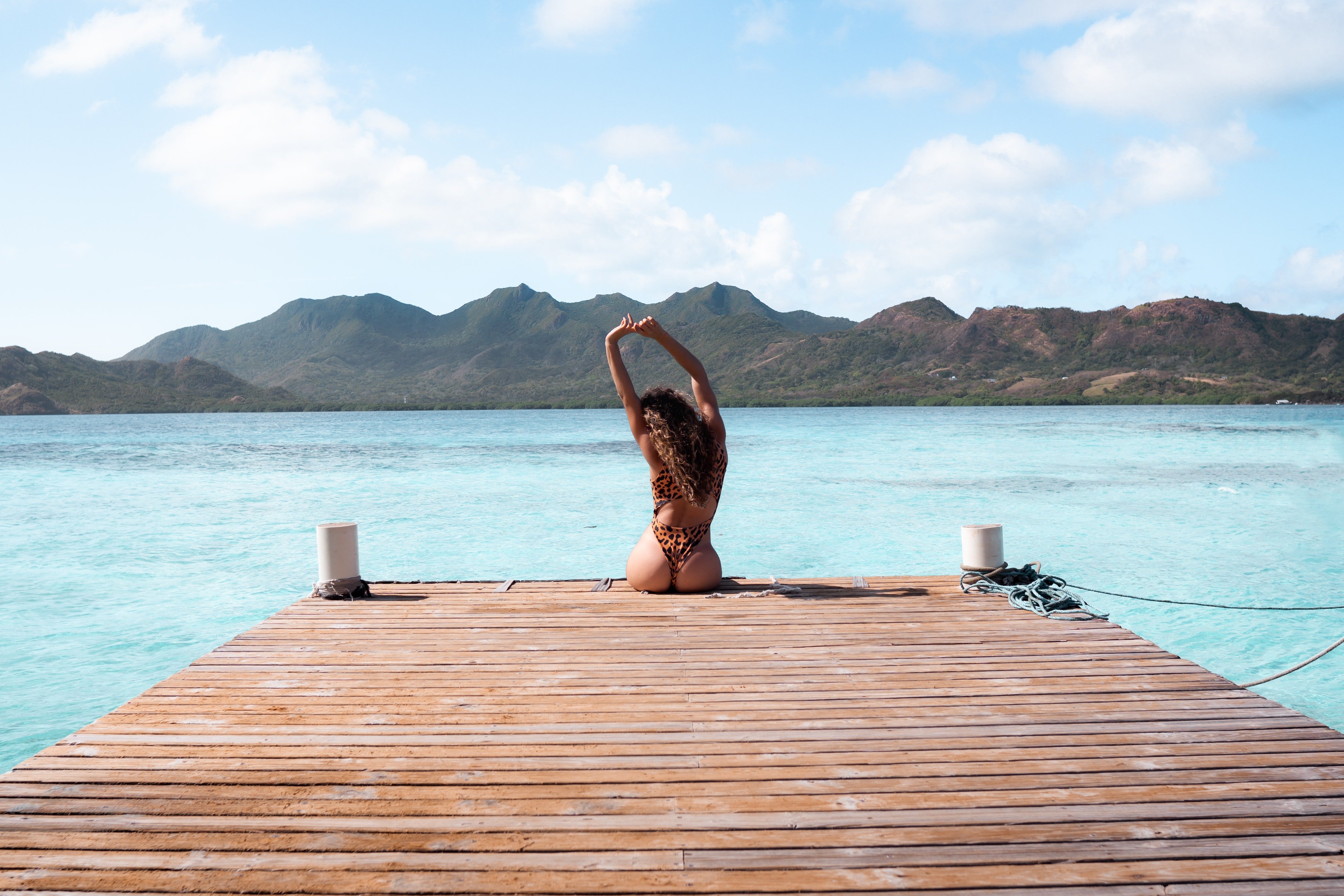 woman sitting on wooden dock