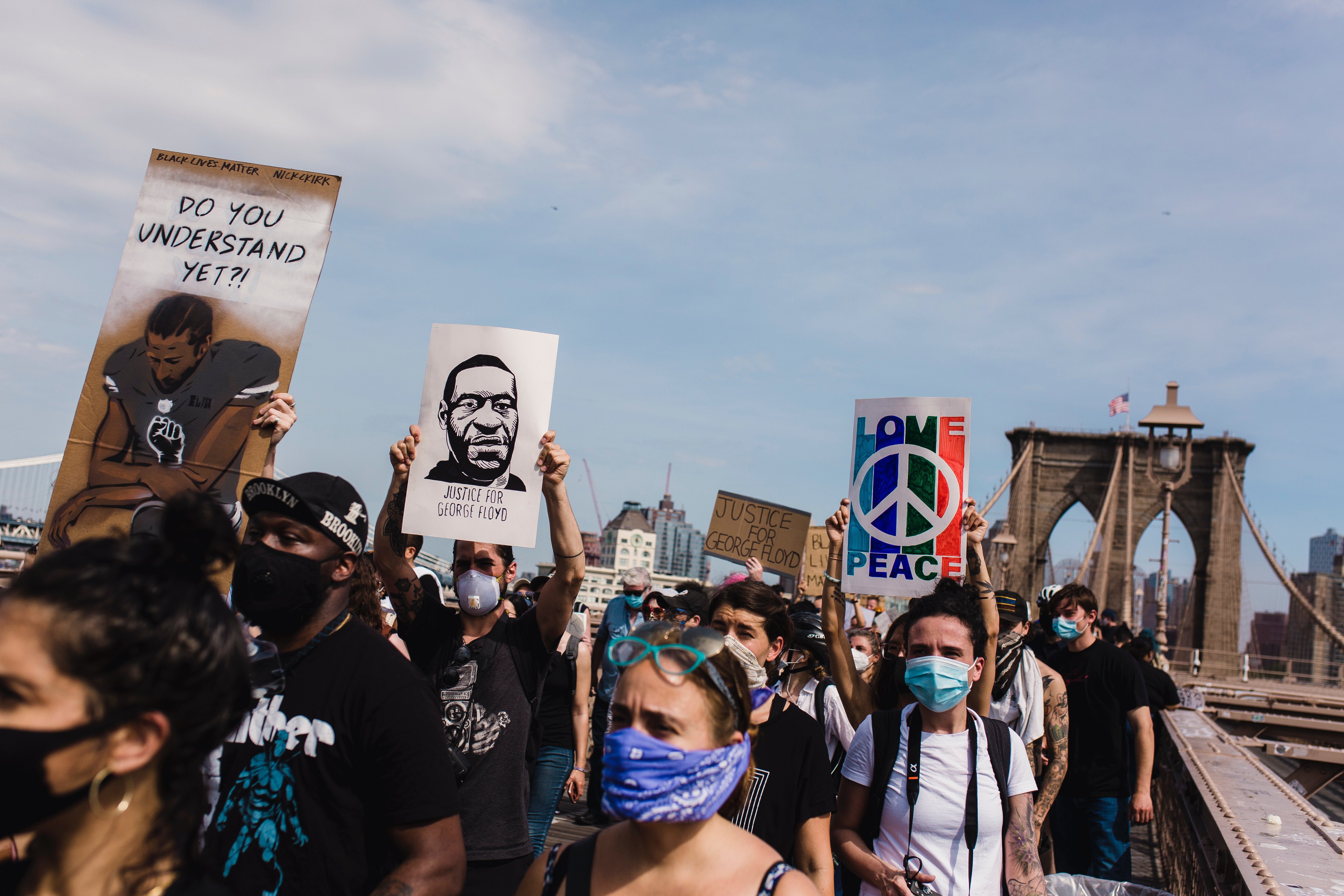 crowd of protesters holding Black Lives Matter signs