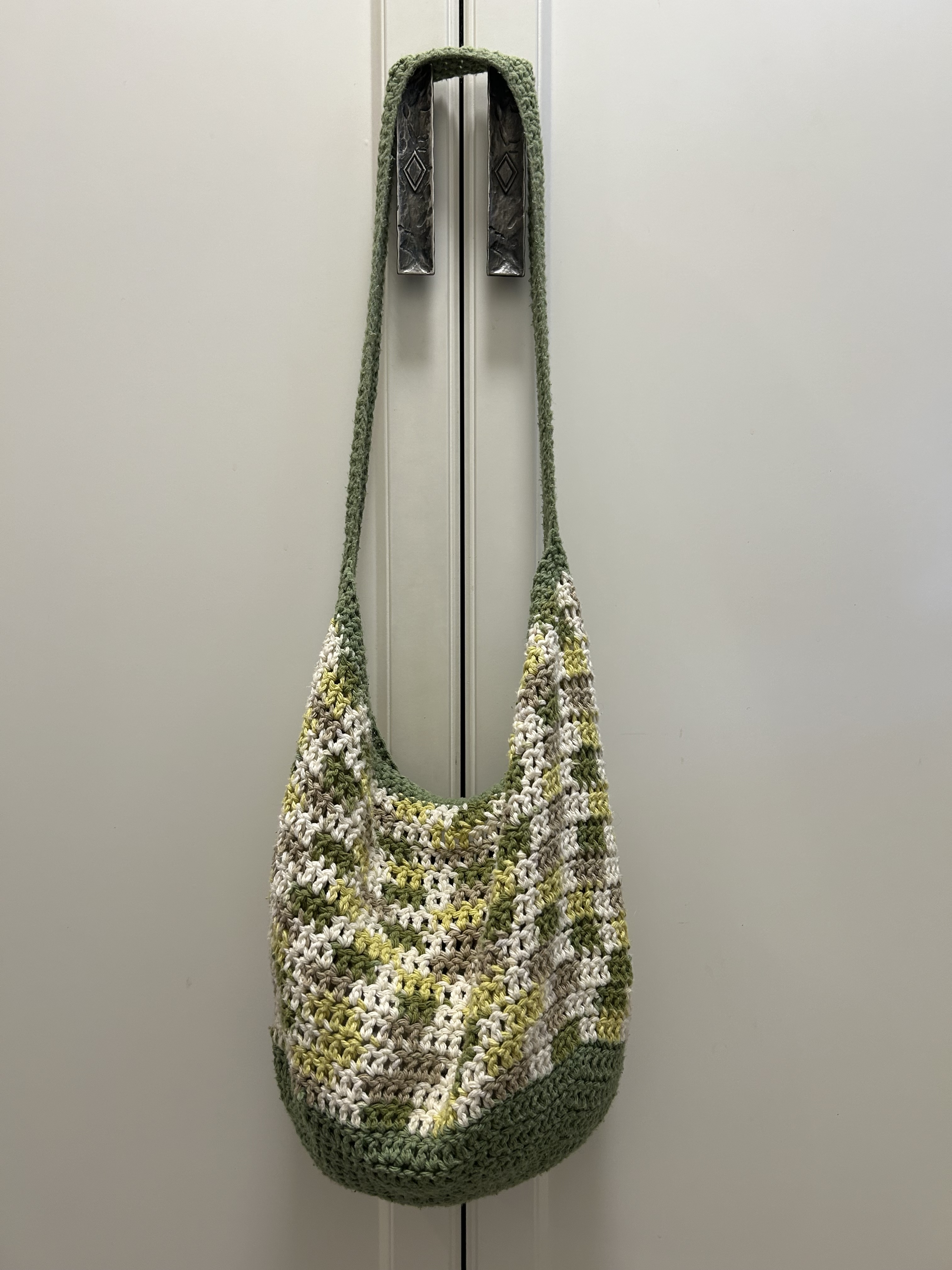 crocheted bag that is green plain background