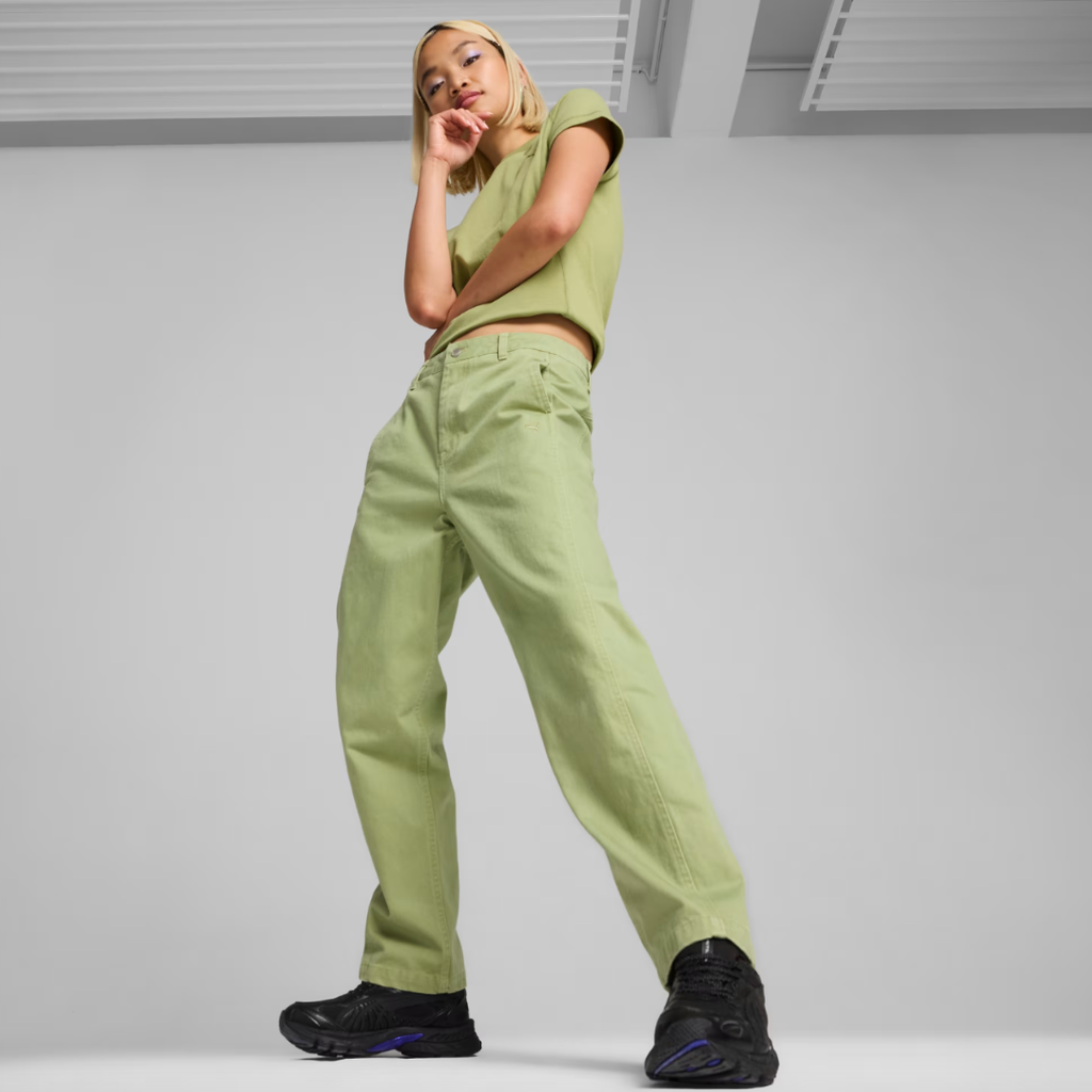 woman wearing green pants, a green tee, and black sneakers