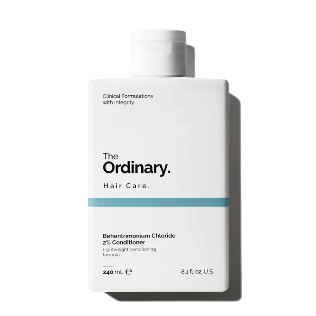 Bottle of The Ordinary Hair Care, a white rectangular design with blue accent, labeled \